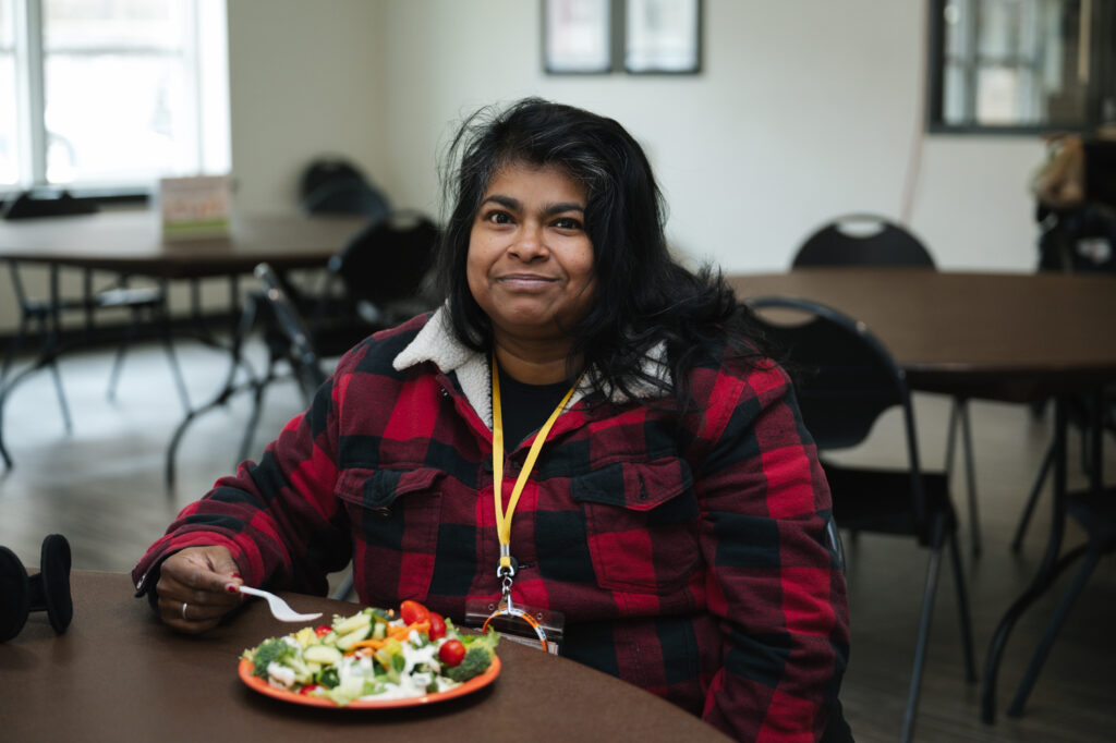 woman eating in dining hall